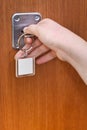 Opening home door by key with blank keychain Royalty Free Stock Photo