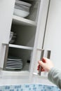 Opening kitchen cabinet Royalty Free Stock Photo