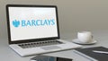 Opening laptop with Barclays logo on the screen. Modern workplace conceptual editorial 4K clip