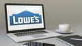 Opening laptop with Lowe`s logo on the screen. Modern workplace conceptual editorial 4K clip