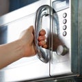 Opening of microwave oven door Royalty Free Stock Photo