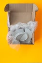 Upon opening, the parcel contained a broken plate, yellow background Royalty Free Stock Photo