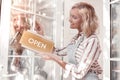 Joyful positive woman putting the sign on the door Royalty Free Stock Photo