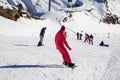 Opening of a ski resort, a young girl on a snowboard on a background of mountains Royalty Free Stock Photo