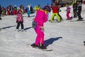 Opening of a ski resort, a young girl on a snowboard on a background of mountains Royalty Free Stock Photo