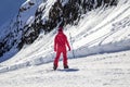 Opening of a ski resort, a young girl on a snowboard on a background of mountains Royalty Free Stock Photo