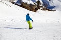 Opening of a ski resort, a young man on a snowboard on a background of mountains. Russia, Sochi Royalty Free Stock Photo