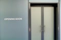 Opening Soon sign on gray obscured shop window Royalty Free Stock Photo