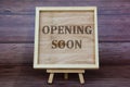 Opening soon text engraved on wooden frame. Business opening concept