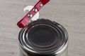 Opening a tin can with a can opener Royalty Free Stock Photo