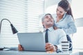 Openly smiling female making massage for her coworker Royalty Free Stock Photo