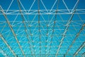 Openwork metal construction on a blue sky background on a clear sunny day, texture backgrounds for graphic design. Royalty Free Stock Photo