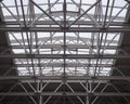 Openwork metal trusses of a huge roof in a hypermarket