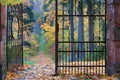 Openwork old iron gate in the autumn park Royalty Free Stock Photo