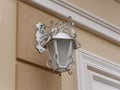 Openwork street lamp on a white wall Royalty Free Stock Photo