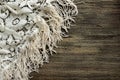 Openwork white tablecloth on the background of old wooden table. Royalty Free Stock Photo