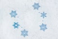 Openwork wooden blue snowflakes on light shiny background with copy space