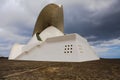 Unusual original non-standard fantastic beautiful large white building in shape resembles a knight`s helmet or a spaceship or a wa