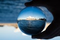 Opera house with Sydney Harbour view photography in clear crystal glass ball with male hand holding.