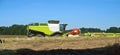 Two agricultural machines operate in the field, grain harvesting machines operate in the field, agricultural land Royalty Free Stock Photo