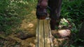 A chainsaw cutting a jack trunk to obtain portions of wood for making door jambs