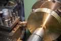 The operation of lathe machine cutting the brass plate parts with the cutting tools.