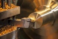 The operation of lathe machine cutting the brass shaft material.