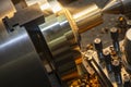 The operation of lathe machine cutting the brass shaft material.