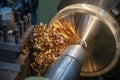 The operation of lathe machine cutting the brass shaft parts with the cutting tools.