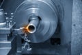 The operation of lathe machine cutting the steel shaft.