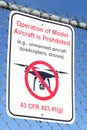 Operation of Model Aircraft Prohibited sign on chain link fence isolated on blue sky background Royalty Free Stock Photo