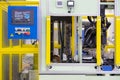 Operation panel with touch screen in front of automation machine