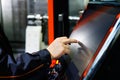 Operator adjusts CNC machine using touch screen