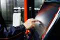 Operator adjusts CNC machine using touch screen Royalty Free Stock Photo