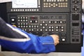 Operator adjusts the parameters of CNC machine