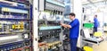 Operator assembles machine in a factory - production of switch c Royalty Free Stock Photo