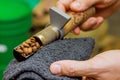 An operator checks roast of variety coffee beans in a natural coffee roasting oven