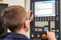 The operator of the CNC milling machine writes the program and makes adjustments for machining parts by cutting. Royalty Free Stock Photo