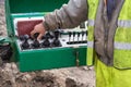 Operator hand on controls of core drilling machine