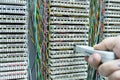 Operator installing telephone switchboard with cables Royalty Free Stock Photo