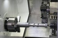 Operator machining automotive part by cnc turning machine, Royalty Free Stock Photo