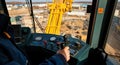 Operator Maneuvering Crane in Industrial Construction Site from Inside Control Cabin Royalty Free Stock Photo