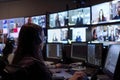 Operator Monitors Multiple Video Feeds in a Control Room, Managing Data Streams Efficiently and Accurately with Advanced