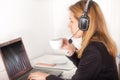 Operator with phone headset drinking coffee Royalty Free Stock Photo