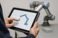 An operator programming a cobot using an intuitive tablet interface Royalty Free Stock Photo