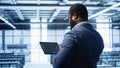 Engineer in data center fixing errors affecting server rows rigs