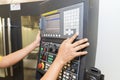 The operator setup the CNC machine milling machine by press the controller keypad.