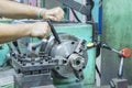 Operator setup turning part on manual lathe machine