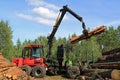 Operator Stacking up Logs with Komatsu 830.3 Forestry Forwarder Royalty Free Stock Photo