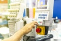 Operator or tailor working on control panel of modern and automatic high technology sewing or embroidery machine for textile -